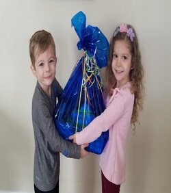 little boy and girl holding a basket