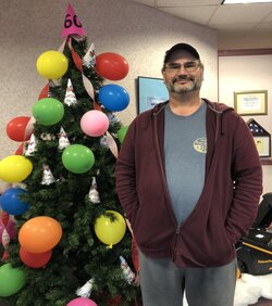man standing in front of decorated tree