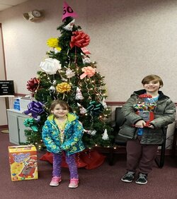 little girl and boy with prize