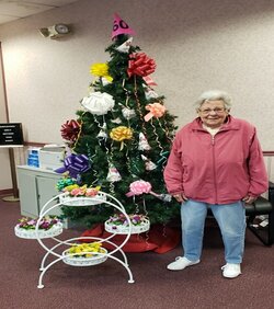 woman with prize in front of tree