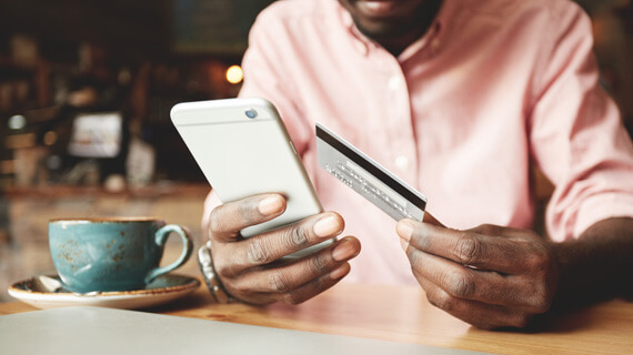 Man holding smart phone and credit card